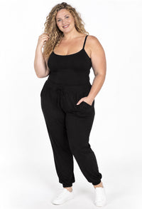 Curvy model in black bamboo camisole and black high-waist travel pants, a soft, stretchy set in sizes 8–24